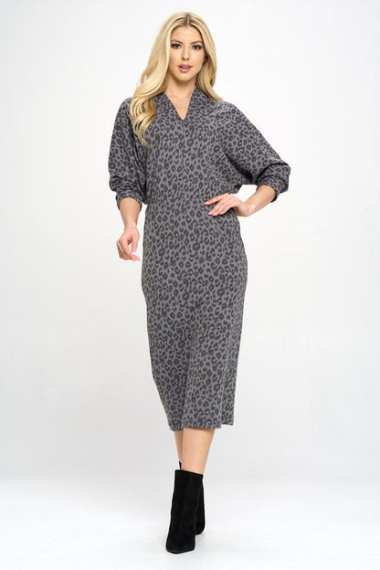 A woman wearing a Leopard Print Knit Dolman Sleeve Midi Dress, full view.