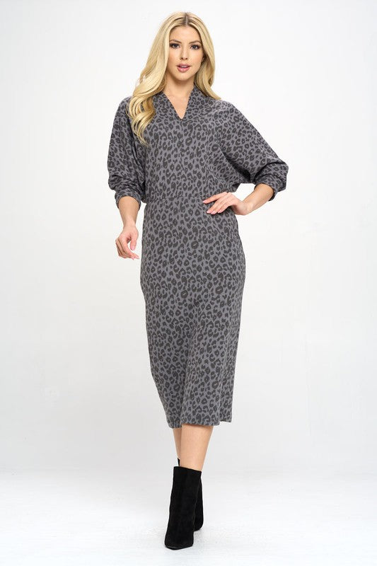 A woman wearing a Leopard Print Knit Dolman Sleeve Midi Dress, full view.
