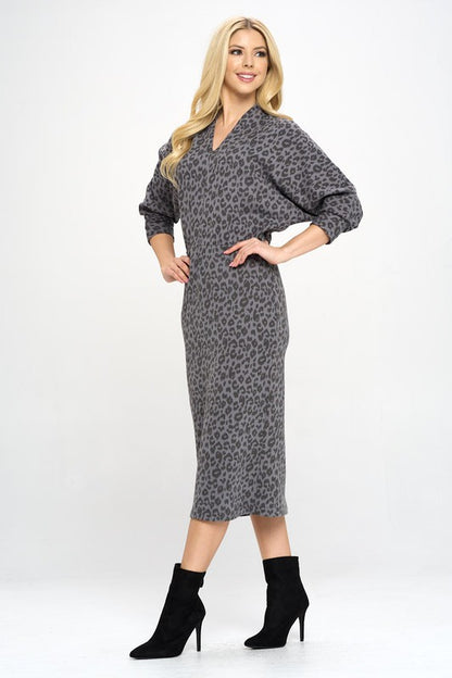 A woman wearing a Leopard Print Knit Dolman Sleeve Midi Dress, posing elegantly.