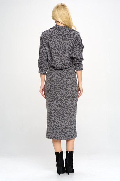 A woman in a Leopard Print Knit Dolman Sleeve Midi Dress, back view.