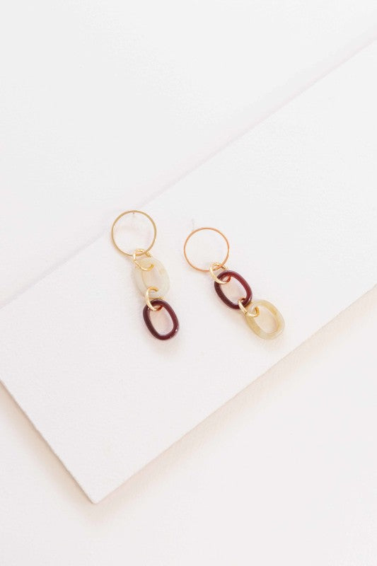Ready to turn heads? These earrings are your new go-to for effortless glam. The Let’s Link Up Dangle Earrings feature a chic trio of gold, maroon, and beige links that dance with every move. Whether you're brunching with besties or dressing up date night, these beauties bring just the right touch of sparkle and sass