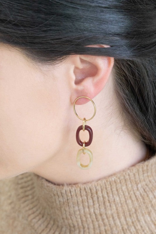 Ready to turn heads? These earrings are your new go-to for effortless glam. The Let’s Link Up Dangle Earrings feature a chic trio of gold, maroon, and beige links that dance with every move. Whether you're brunching with besties or dressing up date night, these beauties bring just the right touch of sparkle and sass