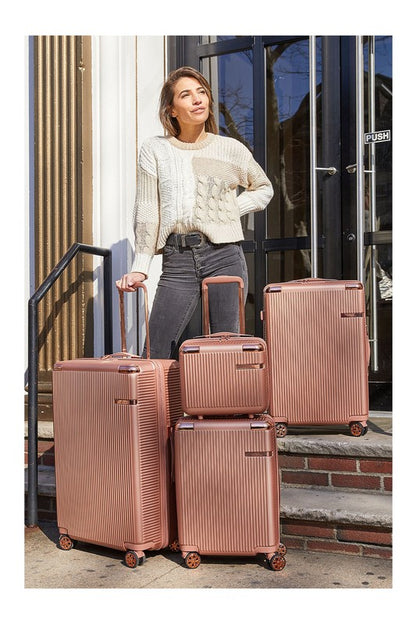 Four-piece hardshell luggage set in varying sizes, featuring a vertical ribbed texture and spinner wheels.