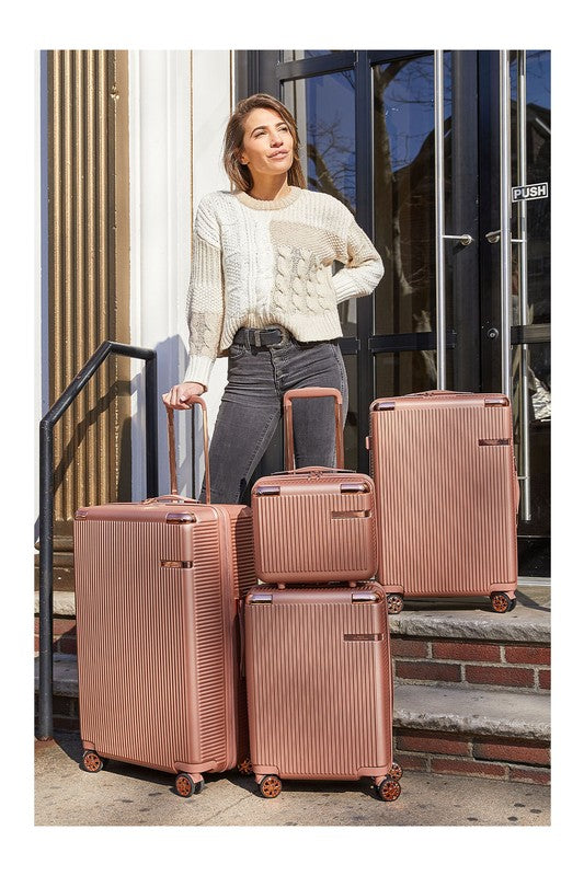 Four-piece hardshell luggage set in varying sizes, featuring a vertical ribbed texture and spinner wheels.