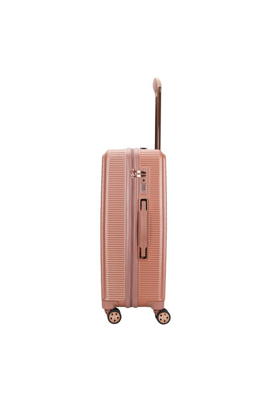 durable hardshell suitcase with a modern geometric textured design and spinner wheels.