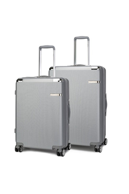 Two silver hard-shell suitcases with vertical ridges, extended telescopic handles, and spinner wheels—standing upright side by side, with one slightly larger than the other.