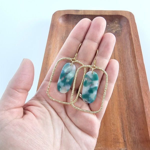 Each piece features a smooth jade-green base kissed with opalescent accents that catch the light like morning dew. Whether you're dressing up for a dinner date or adding polish to your workday wardrobe, these earrings are your subtle statement.