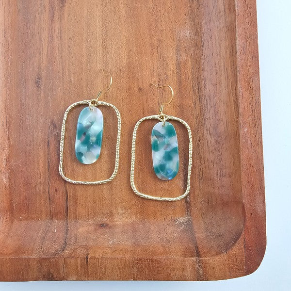 Each piece features a smooth jade-green base kissed with opalescent accents that catch the light like morning dew. Whether you're dressing up for a dinner date or adding polish to your workday wardrobe, these earrings are your subtle statement.