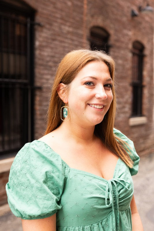 Each piece features a smooth jade-green base kissed with opalescent accents that catch the light like morning dew. Whether you're dressing up for a dinner date or adding polish to your workday wardrobe, these earrings are your subtle statement.