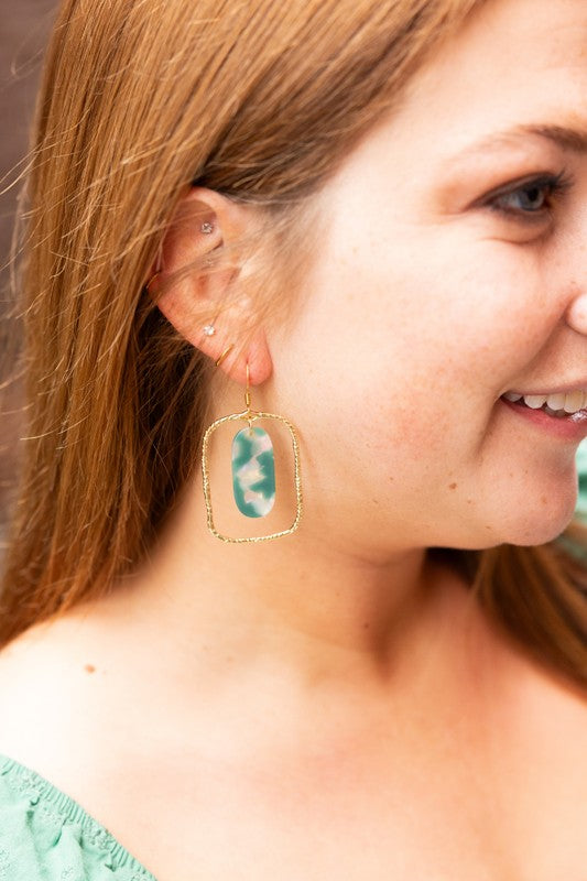 Each piece features a smooth jade-green base kissed with opalescent accents that catch the light like morning dew. Whether you're dressing up for a dinner date or adding polish to your workday wardrobe, these earrings are your subtle statement.