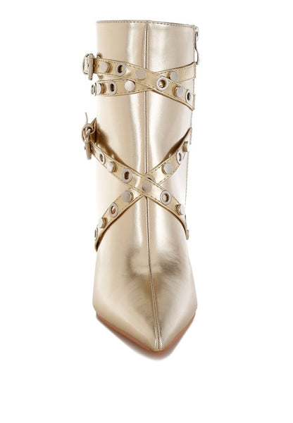 Gold metallic ankle boot with studded details on a white background