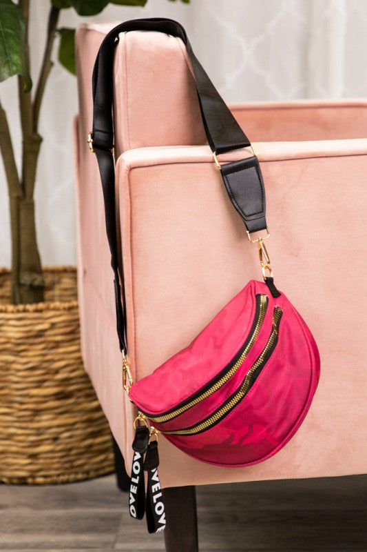 A red crossbody bag with gold zippers and hardware, featuring a wide adjustable strap. Rugged yet stylish—perfect for casual, everyday wear.