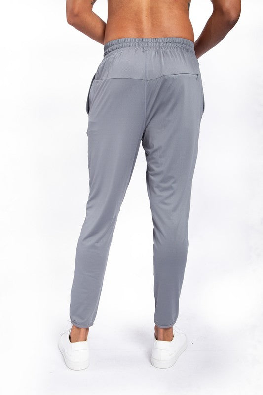 These active bottoms are designed for motion and style. With a tapered leg that adds a modern edge, they deliver a clean silhouette while keeping things flexible and functional. Made from a lightweight polyester-spandex blend, they offer breathability and stretch for workouts, errands, or everyday wear.