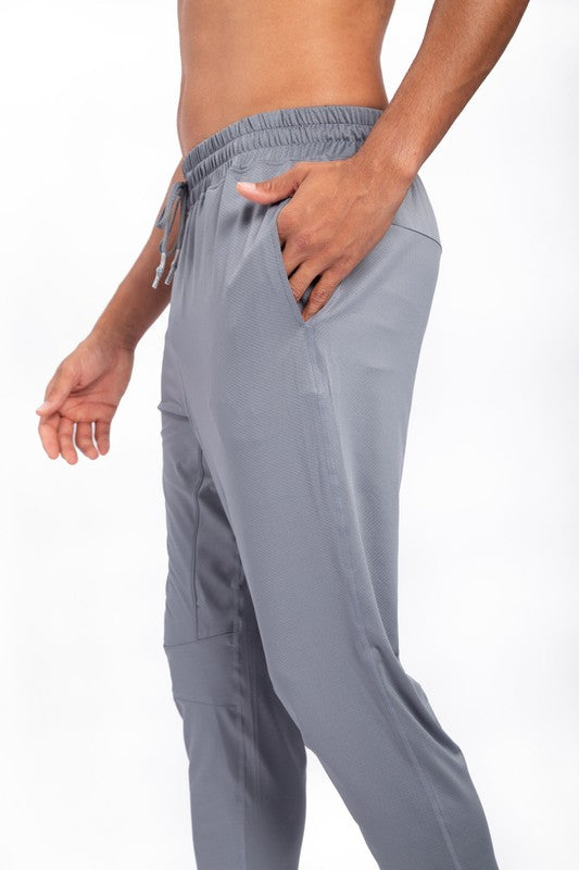 These active bottoms are designed for motion and style. With a tapered leg that adds a modern edge, they deliver a clean silhouette while keeping things flexible and functional. Made from a lightweight polyester-spandex blend, they offer breathability and stretch for workouts, errands, or everyday wear.