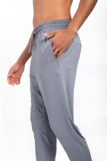 These active bottoms are designed for motion and style. With a tapered leg that adds a modern edge, they deliver a clean silhouette while keeping things flexible and functional. Made from a lightweight polyester-spandex blend, they offer breathability and stretch for workouts, errands, or everyday wear.