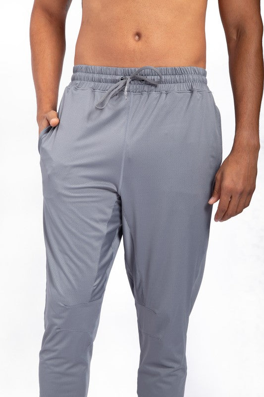 These active bottoms are designed for motion and style. With a tapered leg that adds a modern edge, they deliver a clean silhouette while keeping things flexible and functional. Made from a lightweight polyester-spandex blend, they offer breathability and stretch for workouts, errands, or everyday wear.