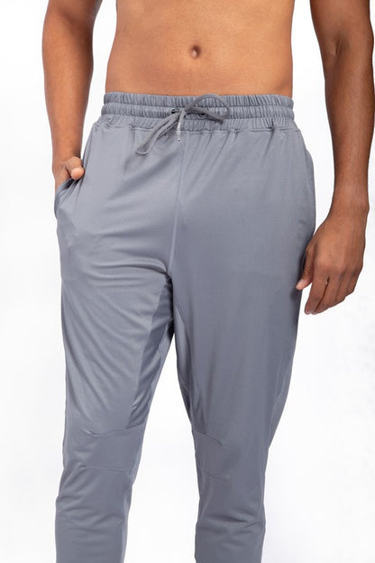 These active bottoms are designed for motion and style. With a tapered leg that adds a modern edge, they deliver a clean silhouette while keeping things flexible and functional. Made from a lightweight polyester-spandex blend, they offer breathability and stretch for workouts, errands, or everyday wear.