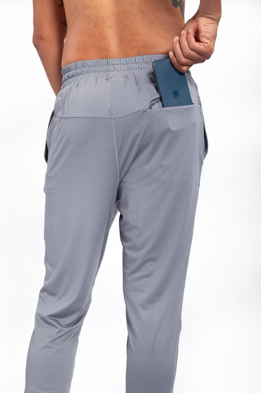 These active bottoms are designed for motion and style. With a tapered leg that adds a modern edge, they deliver a clean silhouette while keeping things flexible and functional. Made from a lightweight polyester-spandex blend, they offer breathability and stretch for workouts, errands, or everyday wear.
