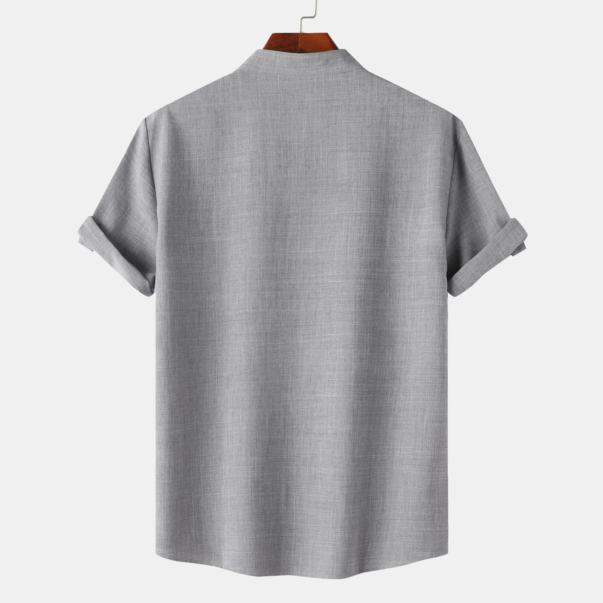 Gray short-sleeve shirt on a hanger with a white background