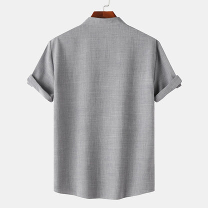 Gray short-sleeve shirt on a hanger with a white background