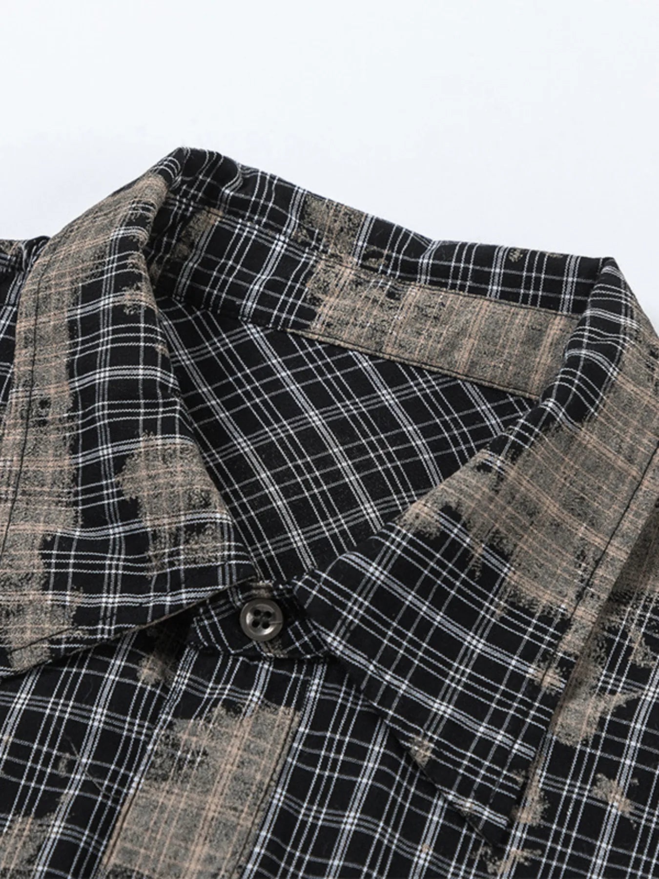 This men's button-down shirt features a distressed plaid pattern for a rugged, casual look and versatile wear.