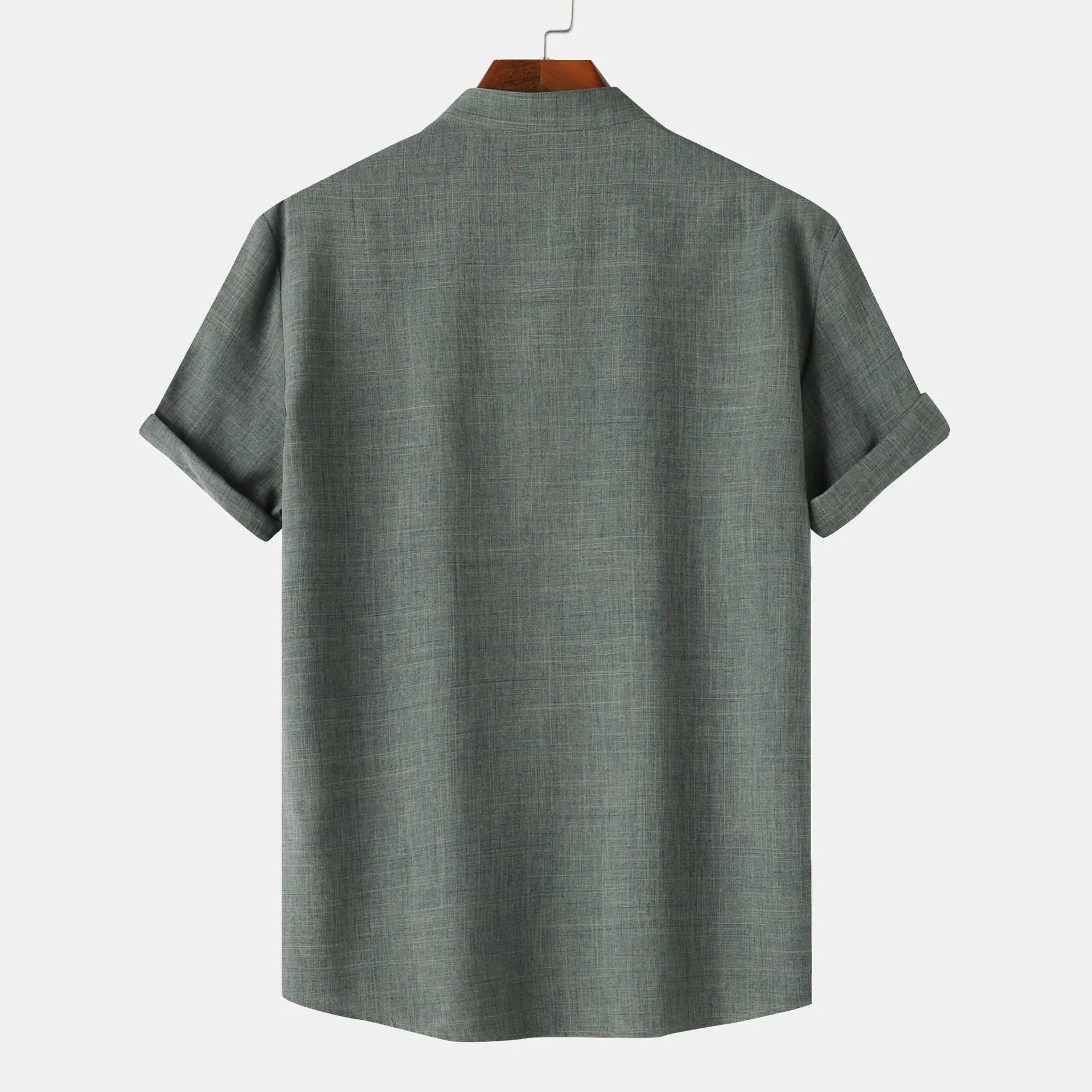 Green shirt on a hanger against a white background