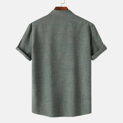 Green shirt on a hanger against a white background