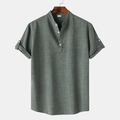 Gray short-sleeve shirt on a hanger against a white background