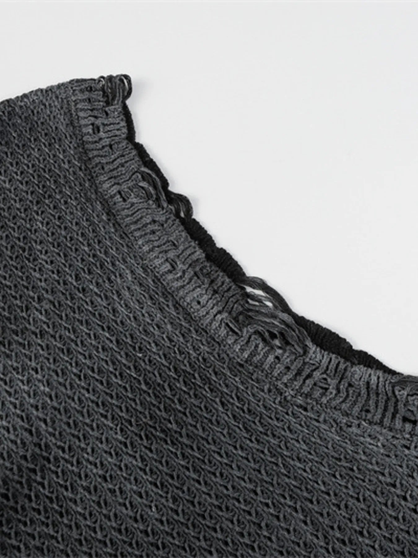 A stylish men’s distressed knit vest featuring intentionally frayed edges for a rugged, contemporary look.