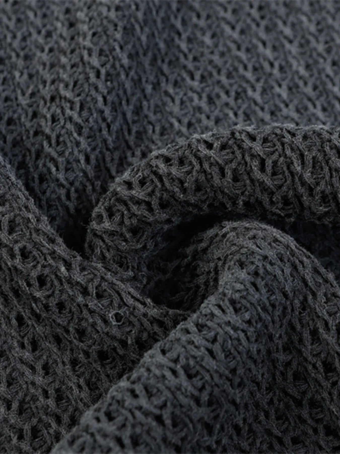 A stylish men’s distressed knit vest featuring intentionally frayed edges for a rugged, contemporary look.