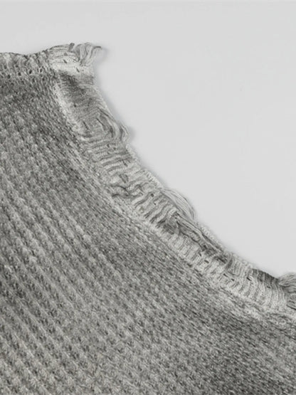 A stylish men’s distressed knit vest featuring intentionally frayed edges for a rugged, contemporary look.