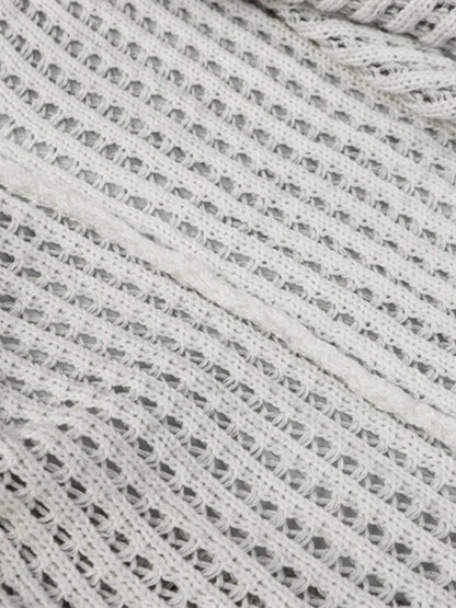 A stylish men’s distressed knit vest featuring intentionally frayed edges for a rugged, contemporary look.

