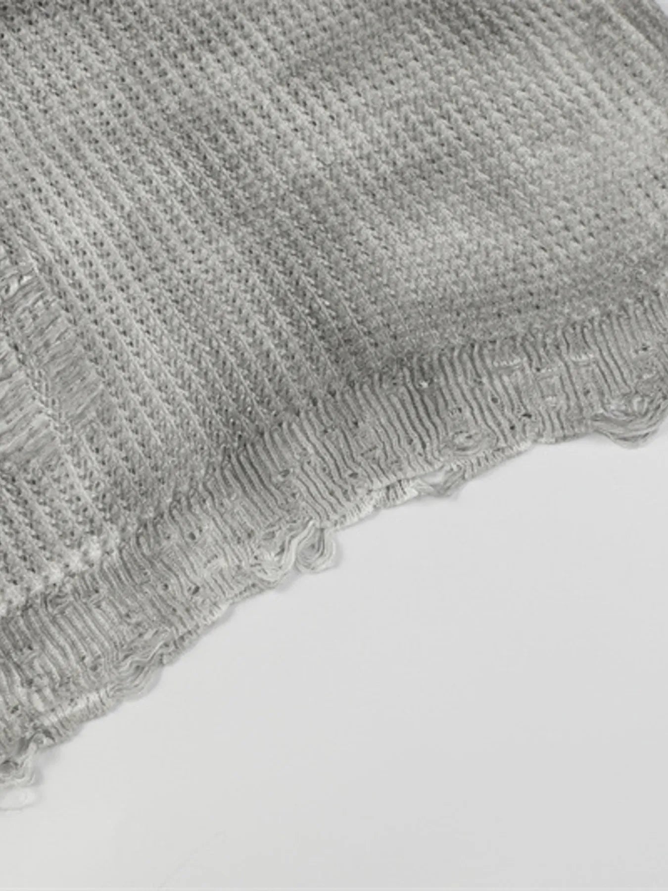 A stylish men’s distressed knit vest featuring intentionally frayed edges for a rugged, contemporary look.