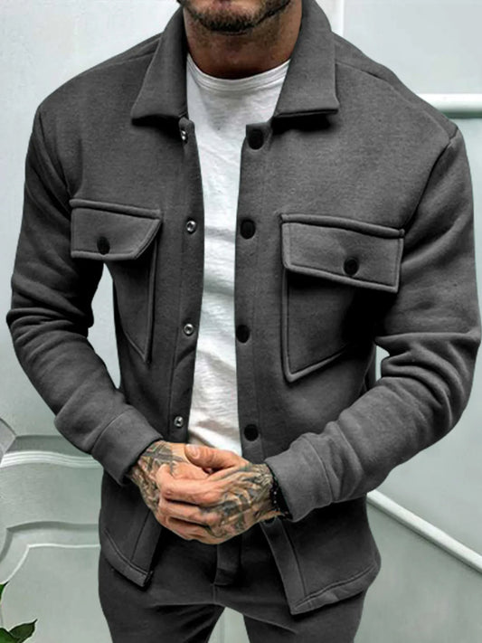 Men’s dark gray button-up long sleeve jacket with front flap pockets, worn over a white t-shirt