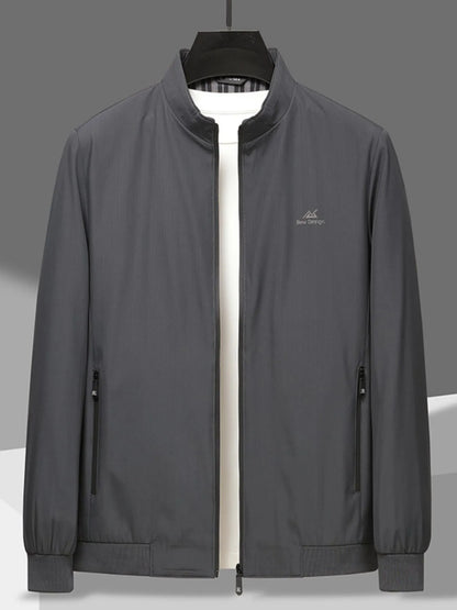 Men’s gray zip-up long sleeve jacket with front zipper pockets, hung over a white t-shirt