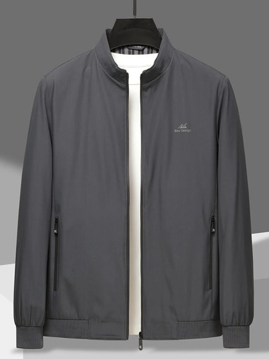 Men’s gray zip-up long sleeve jacket with front zipper pockets, hung over a white t-shirt