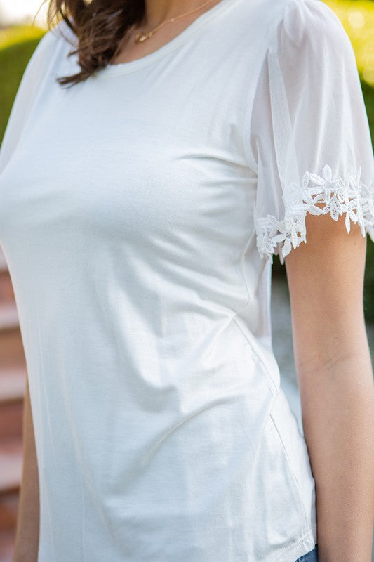 Knit jersey provides comfort and shape; mesh sleeves bring a light, elegant touch.