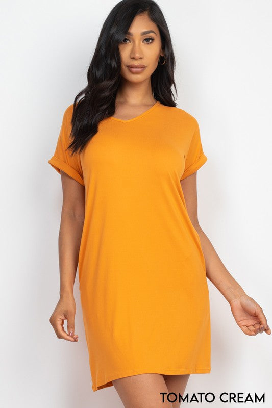 Woman wearing a mustard yellow dress on a white background