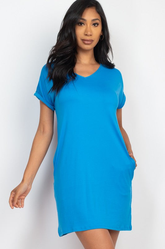 Woman wearing a blue dress against a white background
