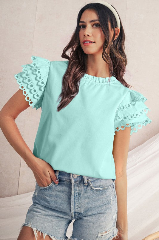 Layered ruffle detailing across the bodice for feminine flair. 