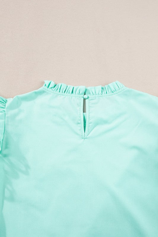 Hem length falls around the hip-to-mid-hip area, depending on size. 