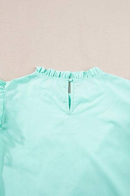 Hem length falls around the hip-to-mid-hip area, depending on size. 