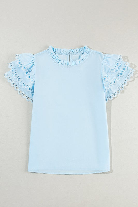Contrasting neck frill balances the overall soft look with structure. 