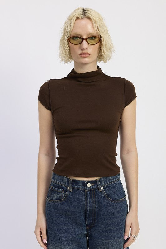 Features a mock neckline that adds a modern, clean silhouette. 