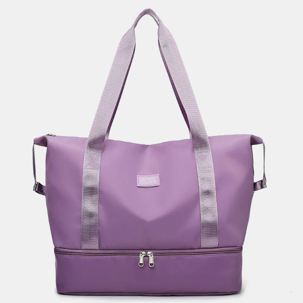 Purple tote bag with dual shoulder straps and a zippered bottom compartment, featuring a sleek design and reinforced stitching. Stylish and practical—great for gym, travel, or everyday use.
