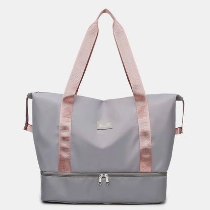 Light gray tote bag with pink handles and dual zippered compartments, set against a soft indoor background. Chic and practical—ideal for gym, travel, or daily use.