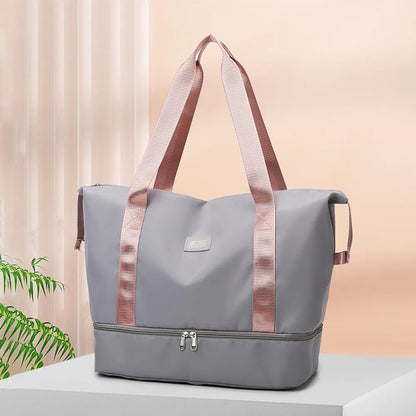 Light gray tote bag with pink handles and dual zippered compartments, set against a soft indoor background. Chic and practical—ideal for gym, travel, or daily use.