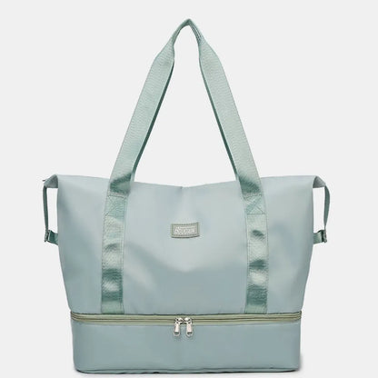 Light blue duffel bags with zippered top and bottom compartments, set against a pastel pink background. Stylish and functional—perfect for travel or gym use.