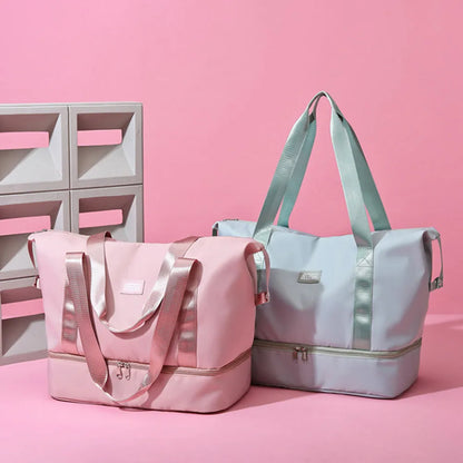 Pink and light blue duffel bags with zippered top and bottom compartments, set against a pastel pink background. Stylish and functional—perfect for travel or gym use.