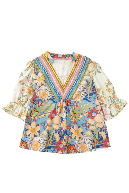 A staple floral blouse that adds pop and personality to any outfit.